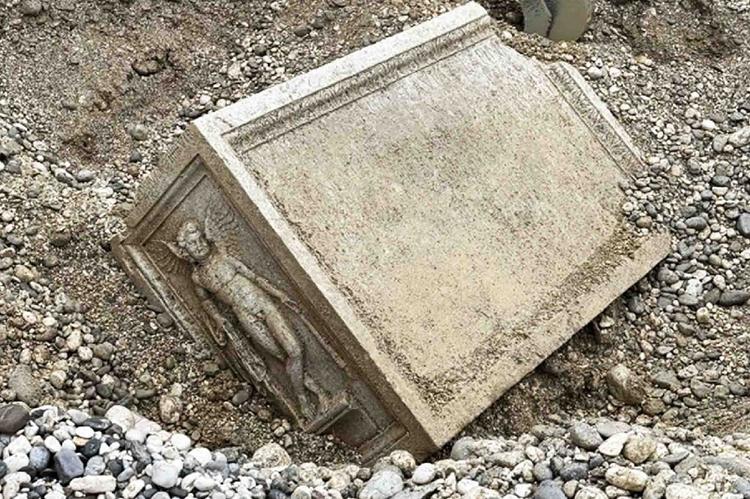 Roman funerary altar found partially buried in Torre river