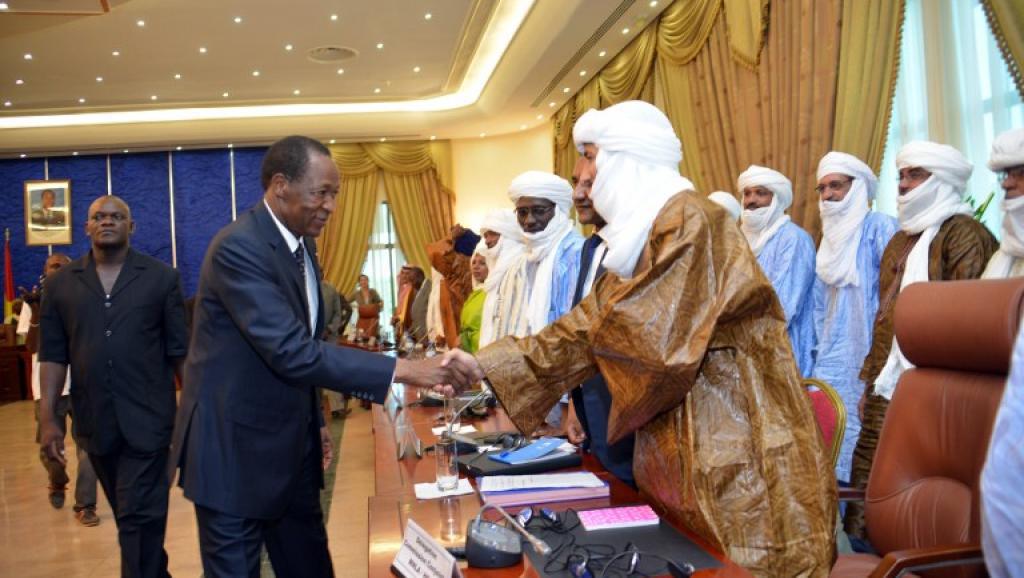 Le président burkinabè, Blaise Compaore (c) salue Bilal Ag Acherif, le secrétaire général du Mouvement national de libération de l'Azawad (MNLA), après la signature de l'accord, le 18 juin 2013 à Ouagadougou. AFP/AHMED OUOBA
