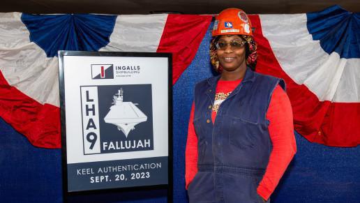 Ingalls welder Seveta Gray etches initials into LHA 9 keel plate Ingalls welder Seveta Gray etches initials into LHA 9 keel plate