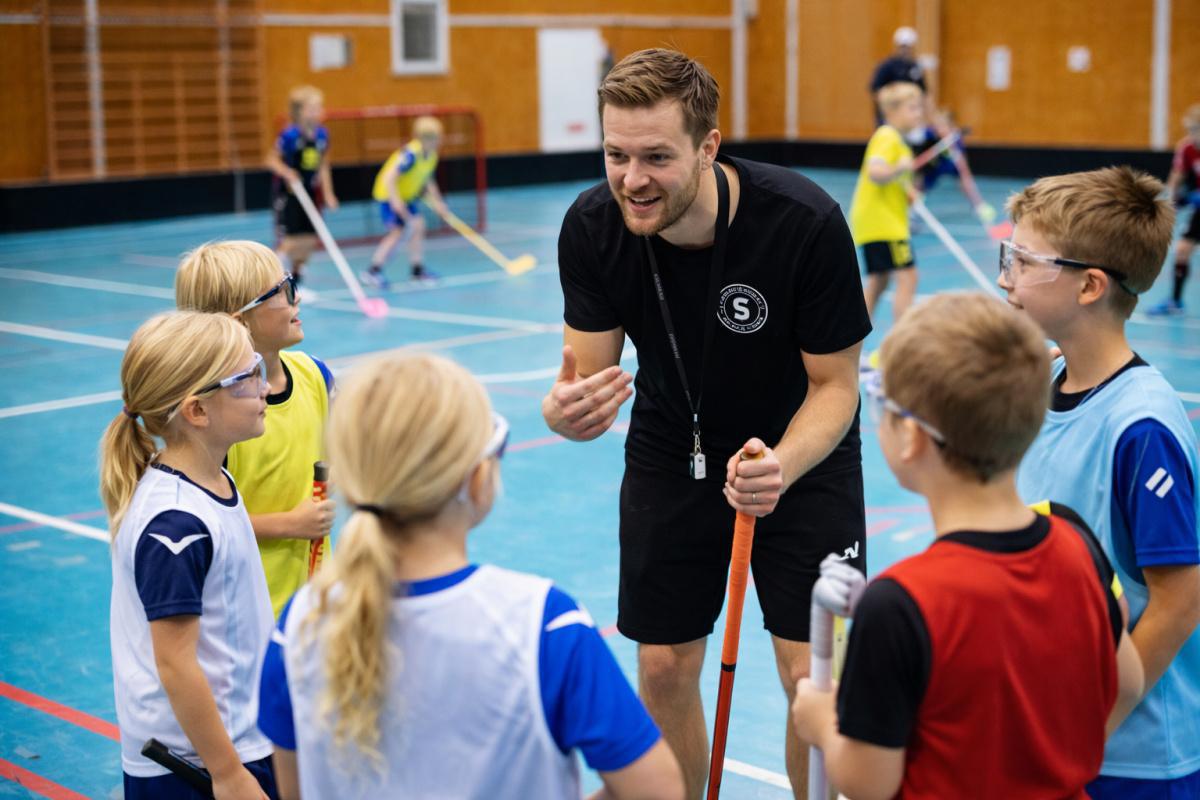 Innebandytränare med i övningar Innebandytränare med i övningar
