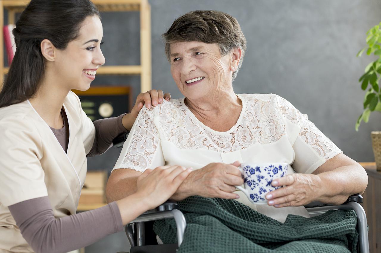 caregiver-talking-to-pensioner-P4YXQNU