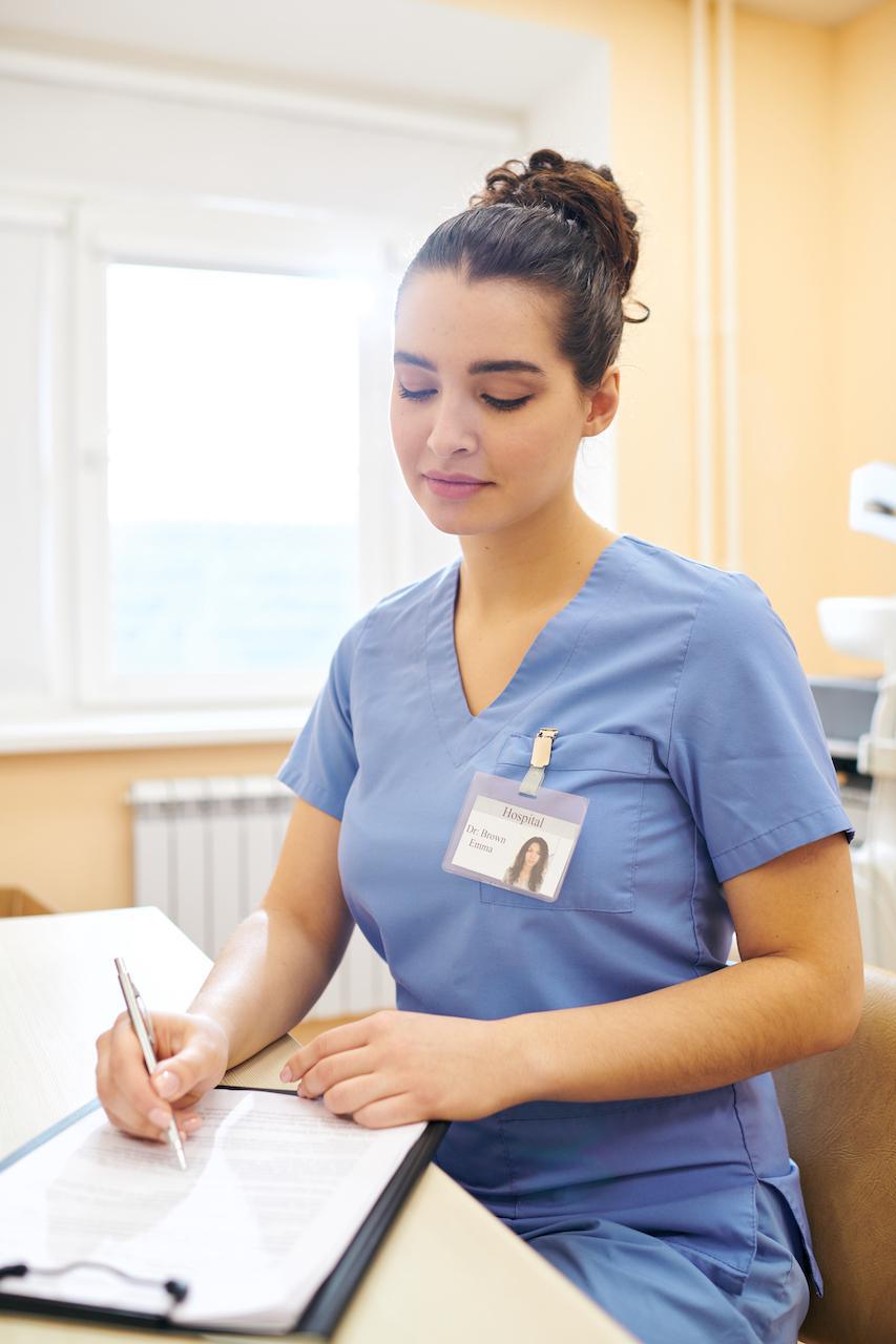 hospital-employee-filling-document-7RM2LEA