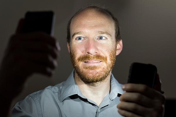 Justin Vandenbroucke, con sus teléfonos-detectores. Imagen: Jeff Miller. Fuente: Universidad de Wisconsin-Madison.