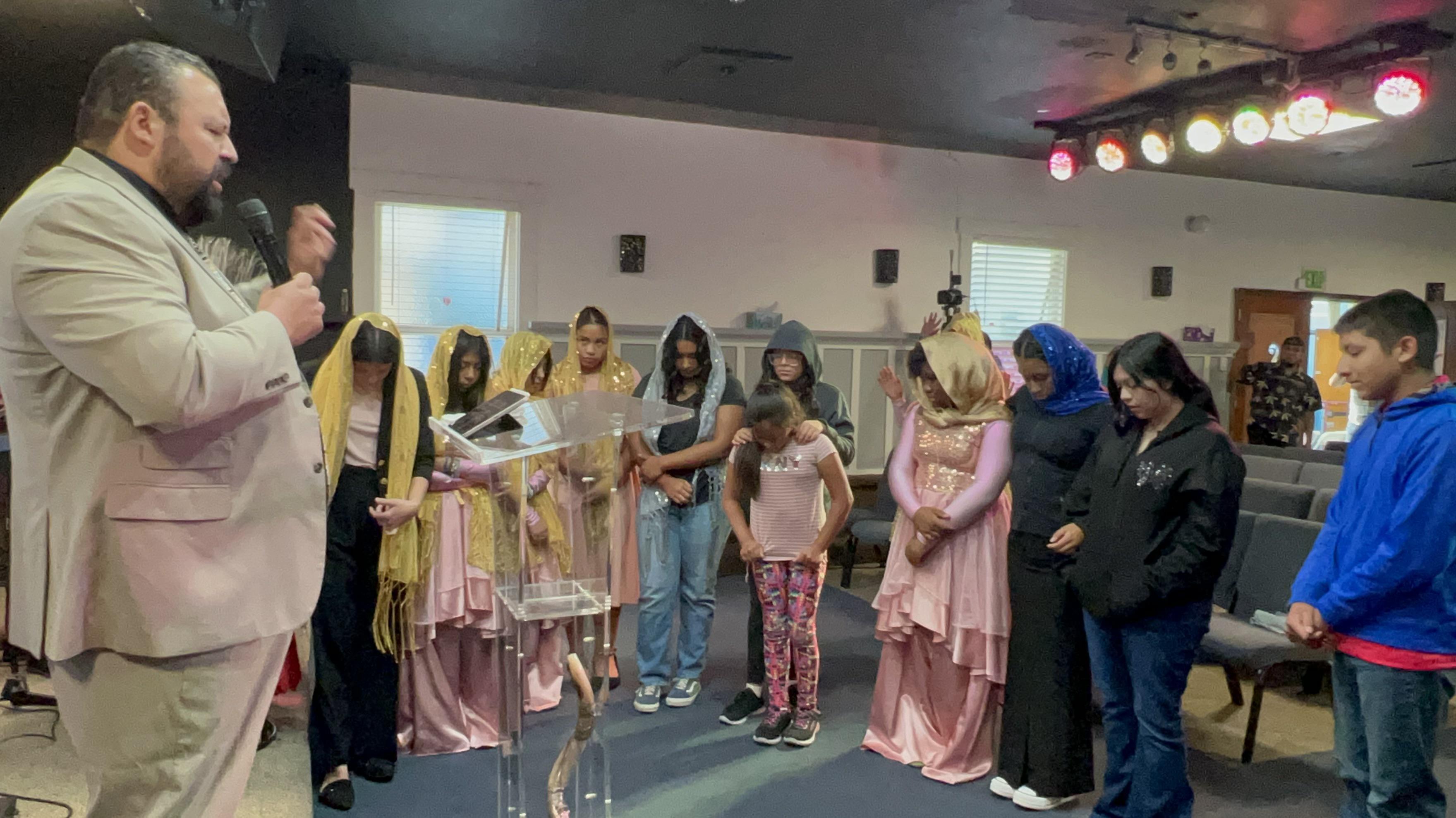 Youth and children receiving blessings for the new school year