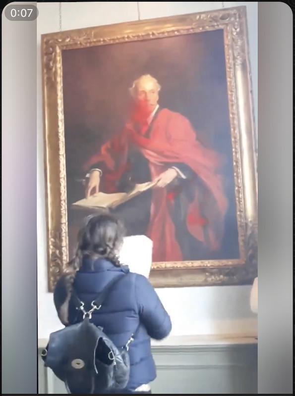 Un militant pro-palestinien découpe le portrait du Premier ministre britannique Arthur Balfour au Trinity College