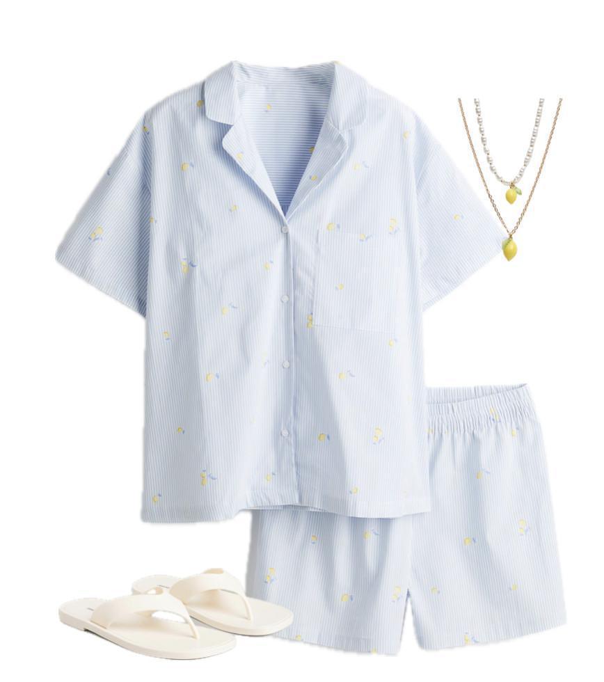 An outfit consisting of a shirt and shorts with a bold lemon print An outfit consisting of a shirt and shorts with a bold lemon print