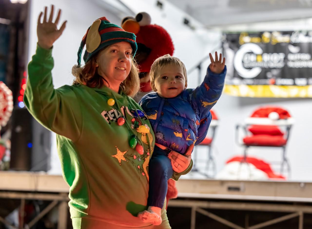 mother and child waving to crowd