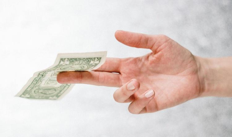 My date wants to tip our restaurant server, my ex; I say no