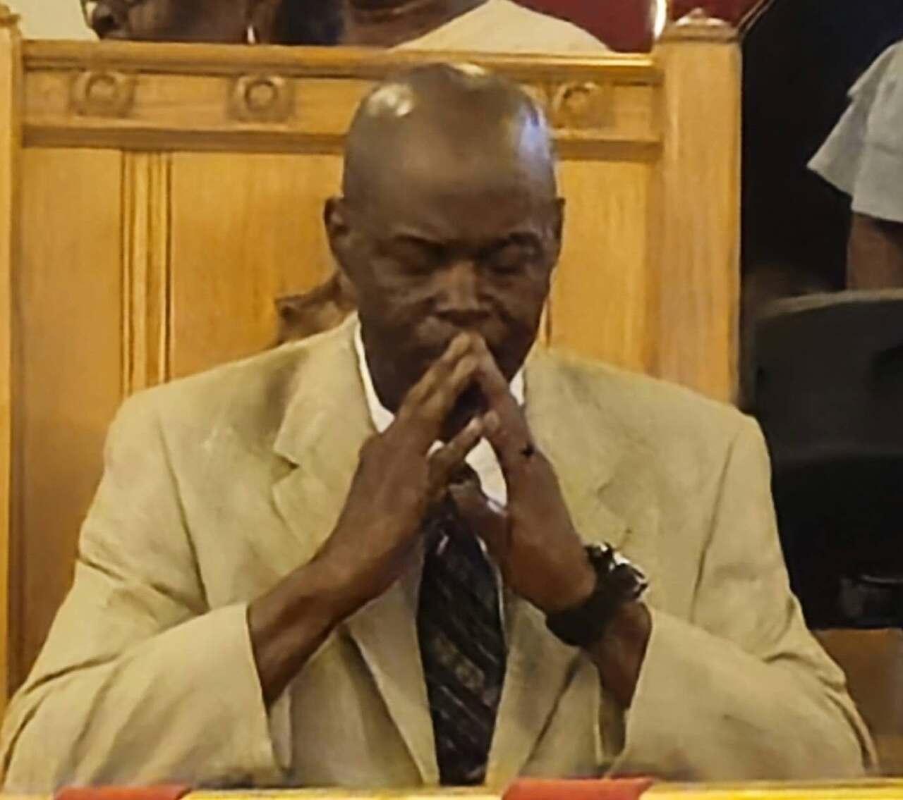 Minister Mines praying