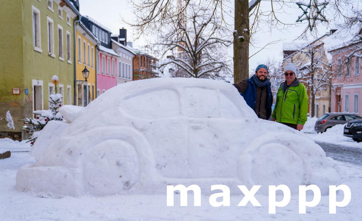 Neighbors build car from snow