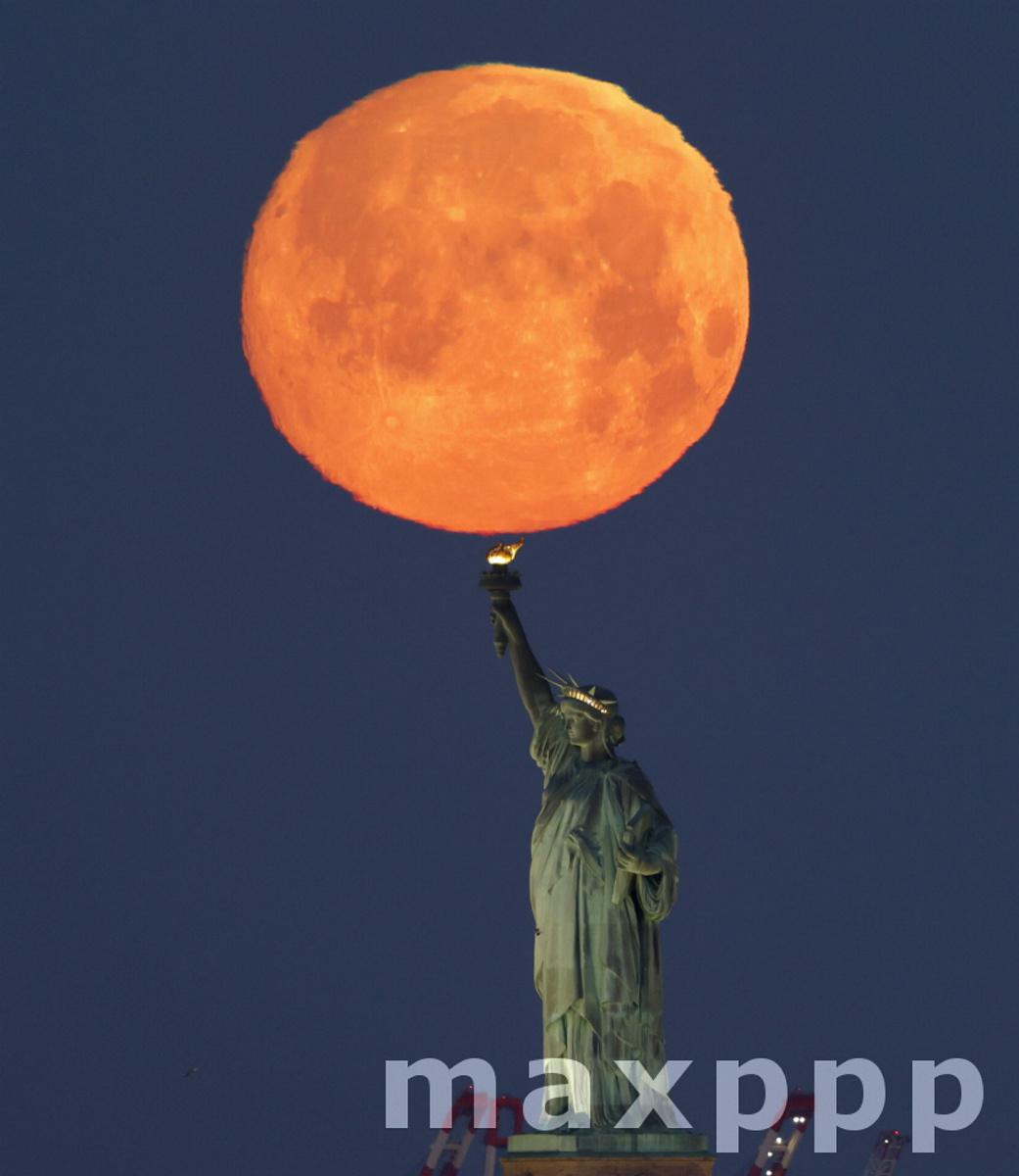 Pink Moon Over the Statue Of Liberty in New York