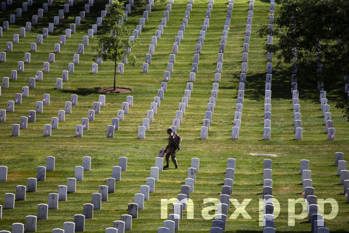 Soldiers place flags at Arlington National Cemetery ahead of Memorial Day