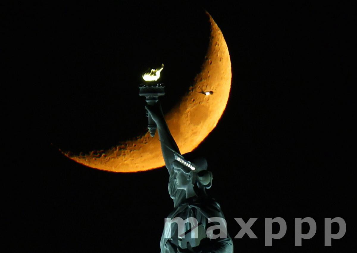 Crescent Moon Sets behind The Statue of Liberty in New York