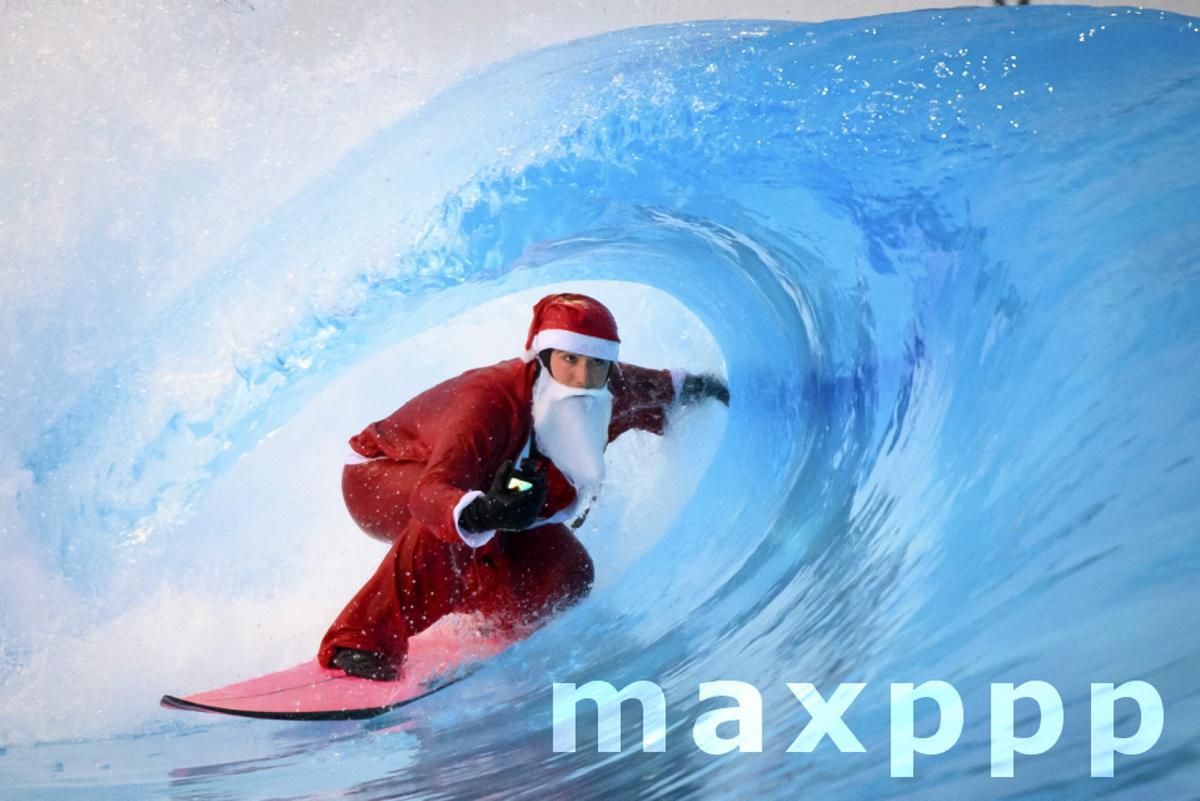 Santa Claus surfs in wavepool in Sion